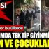 ﻿Kaldırımda tek tip giyinmiş kadın ve çocuklar